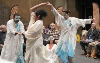 Two dancers spin over Helen in Ten Thousand Thing's production of Helen.