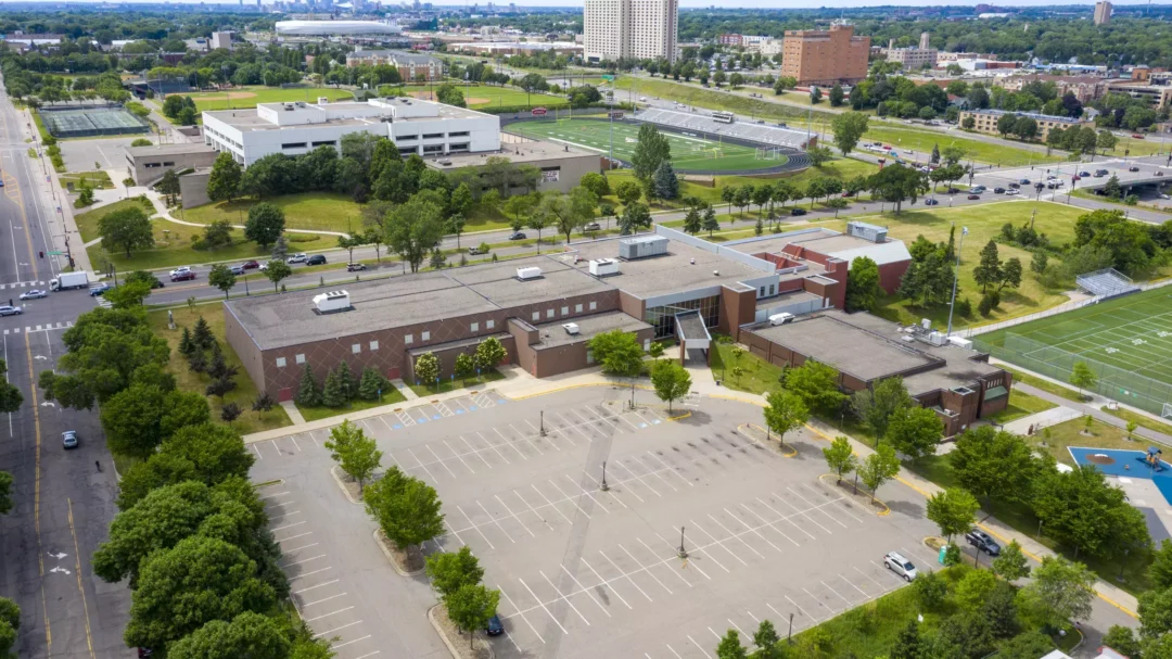 an aerial photo of the Oxford/Jimmy Lee Recreation center, a large red brick building surrounded by a football field, trees, and homes.