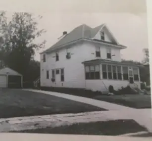 The lovejoy house, ca. 1956. It is a three story victorian, with a four season porch and a detached garage.